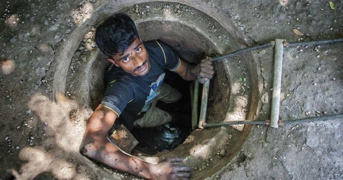Женщина люк. Канализационные ныряльщики в Индии. Человек в канализационном люке. Выглядывает из люка канализационного.